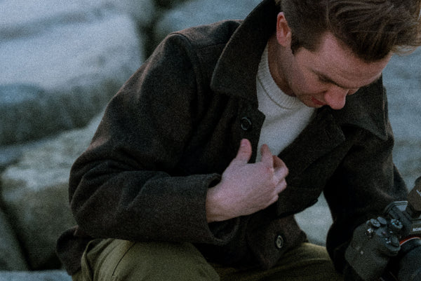 Man bending over wearing the Iron Snail Mammoth jacket.